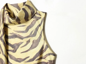 Detail of elegant mock neck sleeveless dress featuring vibrant zebra animal print pattern