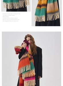 Close-up of thick striped scarf with orange and purple hues and long tassel details
