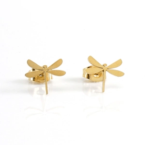 Macro shot of 14k gold-plated stainless steel dragonfly stud earrings on reflective surface