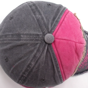 Close-up of distressed vintage denim baseball cap with embroidery and frayed edges