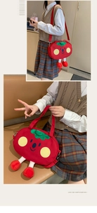 Cute tomato-shaped plush crossbody bag with green leaf decor and soft adjustable straps