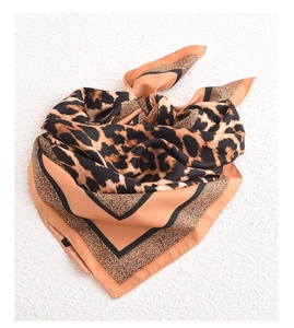 Detailed view of square faux silk scarf featuring classic brown leopard animal print pattern