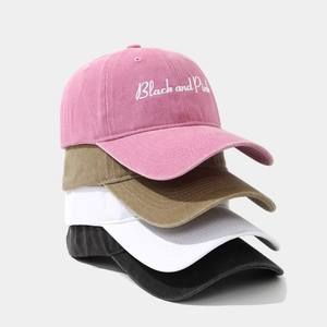 Distressed cotton baseball caps stacked in pink, khaki, white, and black with embroidery