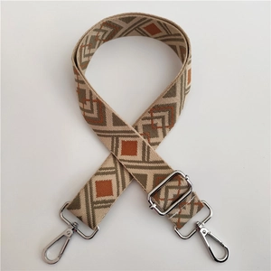 Detail of colorful ethnic jacquard guitar strap for bags with silver metal clips