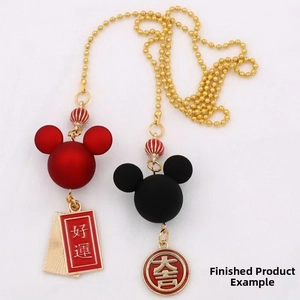 Detail of red and black matte cartoon charms with Good Fortune gold Chinese characters