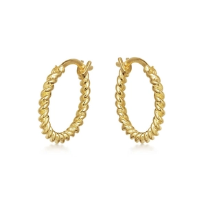 Macro detail of gold-plated twisted hoop earrings with a textured spiral metal design