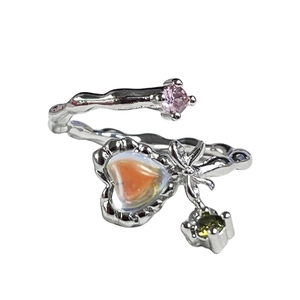 Silver bow ring with heart moonstone and colored gems on a branch-textured open band