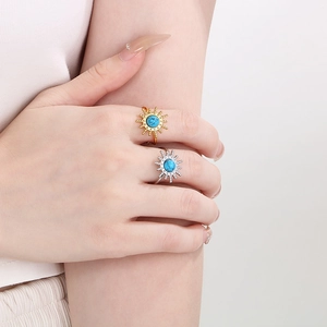 Detail of vintage starburst ring set with turquoise stone on golden and silver bands