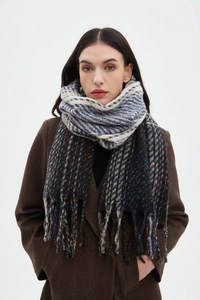 Detail of navy blue and grey checkered scarf with colorful speckles and fringe tassels