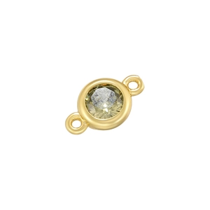 Detail of round gold connector with faceted yellow-green gemstone for DIY jewelry making