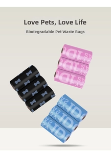 Detail of biodegradable pet waste bags in rolls featuring bone patterns and lettering