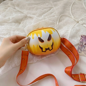 Close-up of orange gradient pumpkin crossbody bag with matching striped strap