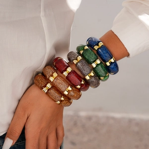 Detailed close-up of acrylic segments with colorful glitter and gold metal connectors