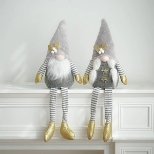 Detail of grey Christmas gnomes with gold sequin accents and striped long legs