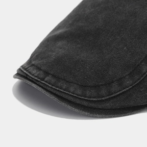 Detail shot of multi-stitch brim and washed texture on vintage black cotton beret cap