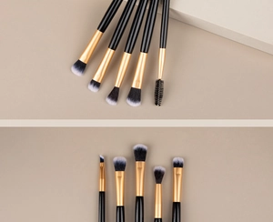 Detailed view of dual-ended makeup brushes with gold ferrules and synthetic bristles