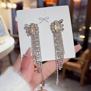 Detail of long 925 silver tassel earrings with sparkling cubic zirconia crystals