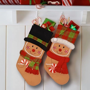 Pair of gingerbread man themed Christmas stockings hanging as festive holiday decorations