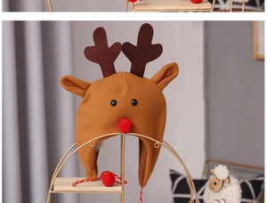 Close-up of a brown felt Christmas reindeer hat for kids with red nose and antlers