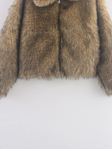 Detail of faux fur texture and metal zipper on brown plush jacket for women