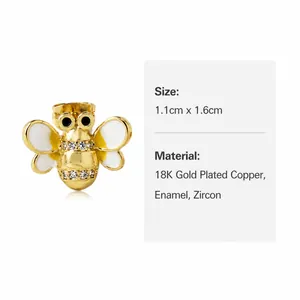 Vue détaillée des boucles d'oreilles abeille plaquées or 18k avec zircons et émail blanc