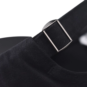 Macro detail of adjustable metal slide buckle on black cotton baseball cap strap