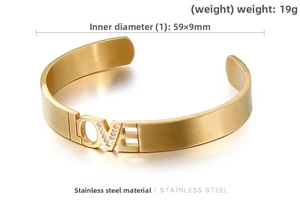 Detail of gold LOVE stainless steel cuff bracelet with white rhinestones on V letter