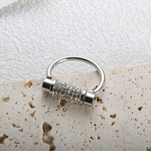 Macro shot of silver ring with rotating pavé diamond cylindrical detail on stone