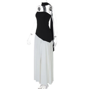 Close-up of elegant black strapless top and white pleated slit skirt on a mannequin