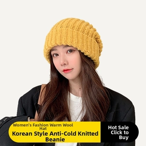 Detail of a thick yellow knit slouchy beanie for women with vertical ribbed texture