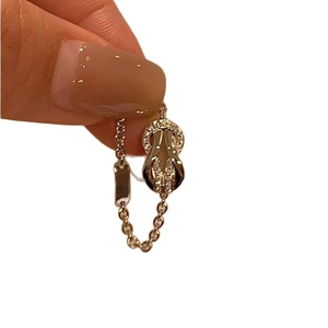 Gold plated horseshoe buckle ring with sparkling cubic zirconia on a minimalist chain