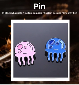 Detail of pink and blue enamel jellyfish brooches with glossy finish and metal edges