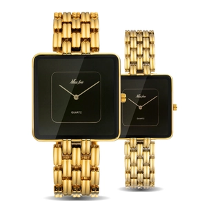 Detailed view of gold square quartz couple watches with black dials and metal straps