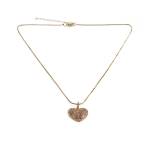 Detail of a gold-plated necklace featuring a heart pendant with pink cubic zirconia
