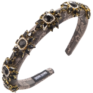Close-up of vintage baroque padded headband with black crystal flower motifs and hand made label