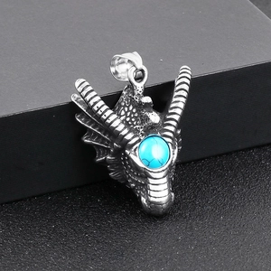 Macro shot of a punk dragon head pendant in vintage silver with turquoise gemstone