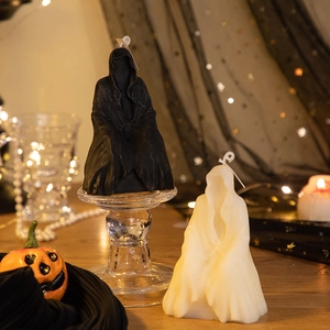 Detail of hooded skeleton scented candles in black and white for Halloween decor