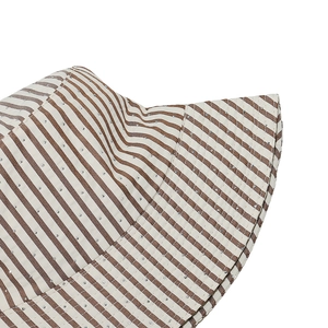 Detailed view of striped sun hat featuring brown and white stripes with sparkling rhinestones