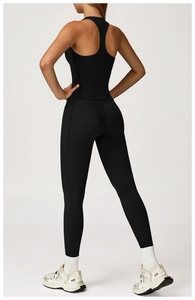 Detail of black racerback yoga set featuring high-waist leggings with side pockets