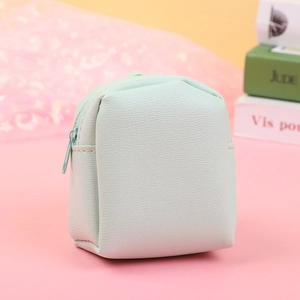 Close-up of litchi pattern PU leather stitching on a mint green mini coin purse