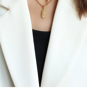 Detail of 18K gold-plated oval relief portrait pendant necklace on a chunky chain