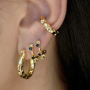 Elegant gold round zircon hoop earrings and black gemstone ear studs set worn by model