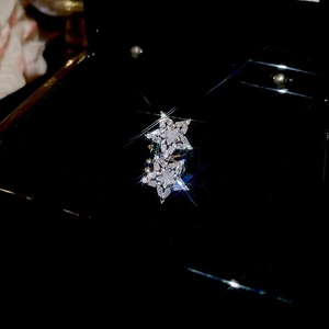 Macro view of crystal zircon star ear cuffs with silver finish on black velvet display