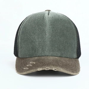 Close-up of distressed brim detail on a vintage olive and brown trucker hat