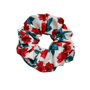 Floral scrunchie with red rose print on white fabric for elegant hair styling