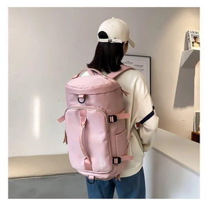 Close-up of pink large capacity travel backpack made of waterproof fabric with side buckles