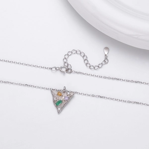 Macro shot of S925 sterling silver triangle pendant with colorful inlaid gemstones