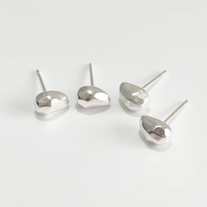 Close-up of small 925 sterling silver earrings with irregular pebble shape and mirror finish