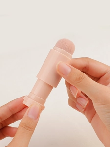 Detail of pink 4-in-1 portable makeup brush showing telescopic design for travel