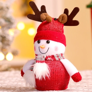 Detailed view of a Christmas snowman doll with red knitted hat and reindeer antlers decor